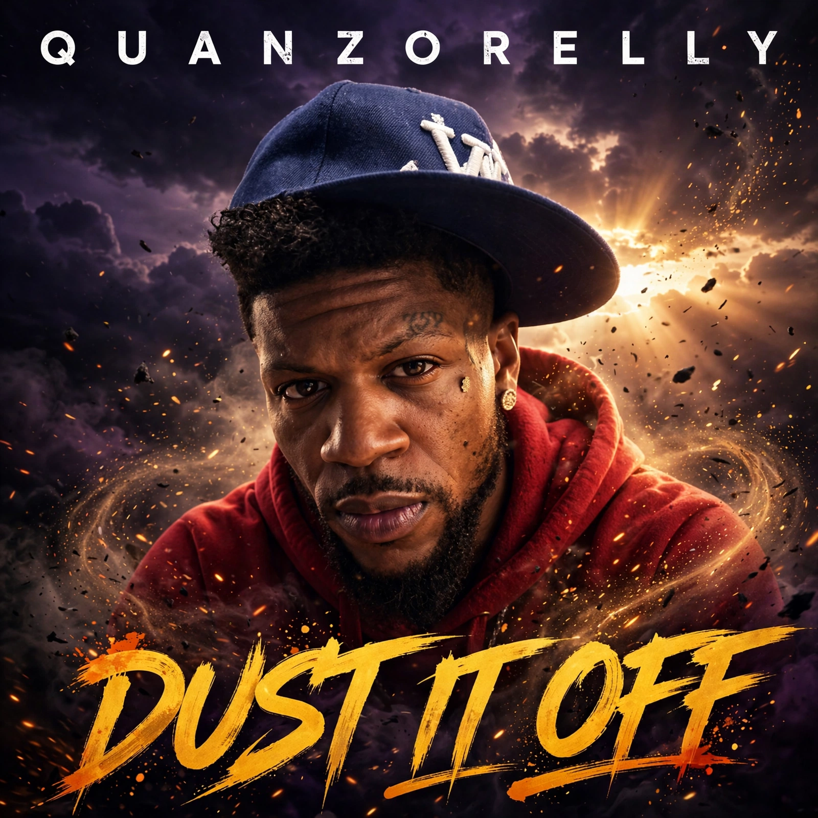 Dust It Off single cover — QuanZoRelly front and center in a red hoodie and navy cap, dust and embers swirling around him with a sunrise behind him, QUANZORELLY across the top and DUST IT OFF in gold graffiti lettering at the bottom